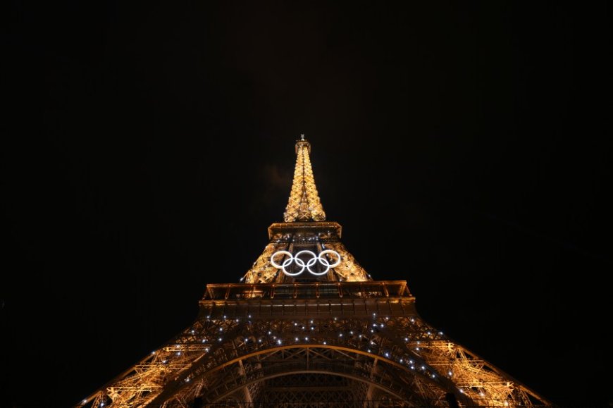 Eiffel Tower evacuated after man climbs up to Olympic rings